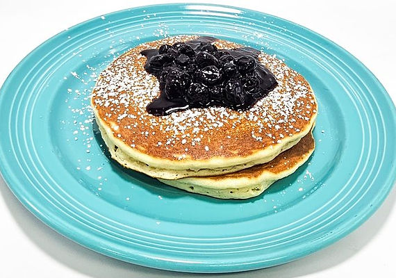Blueberry pancakes served on a turquoise plate
